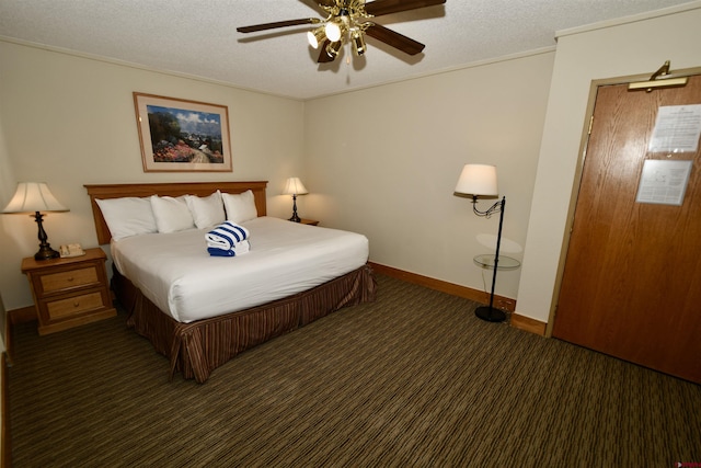 carpeted bedroom featuring ceiling fan, crown molding, and a textured ceiling