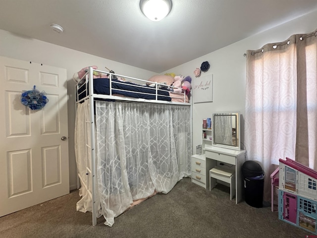 bedroom featuring dark carpet