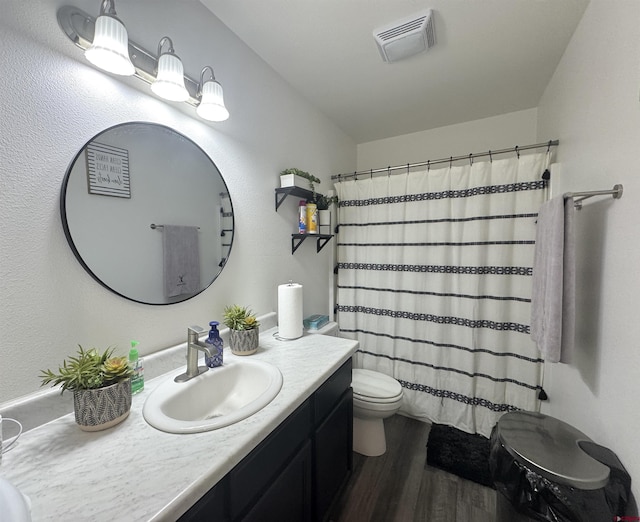 bathroom featuring toilet, hardwood / wood-style flooring, a shower with curtain, and vanity