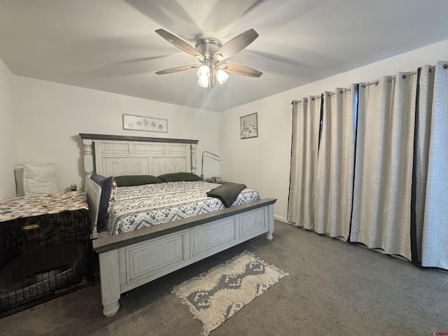 bedroom with ceiling fan and dark colored carpet