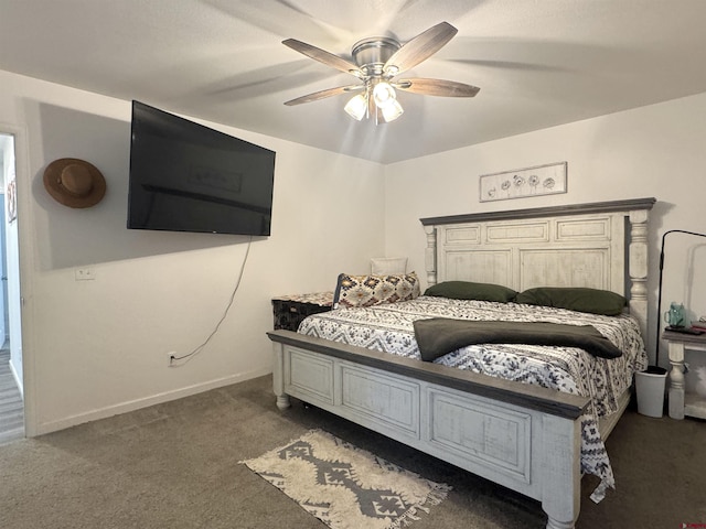 bedroom with ceiling fan and dark colored carpet