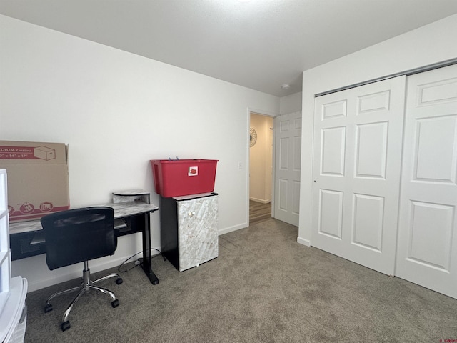 office area featuring light carpet