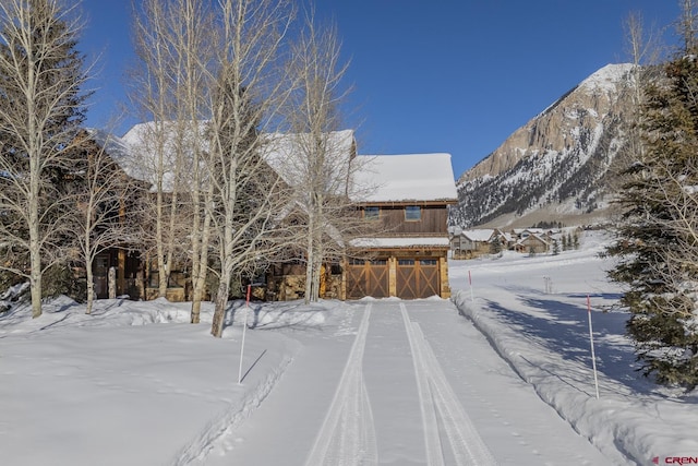 exterior space with a garage and a mountain view