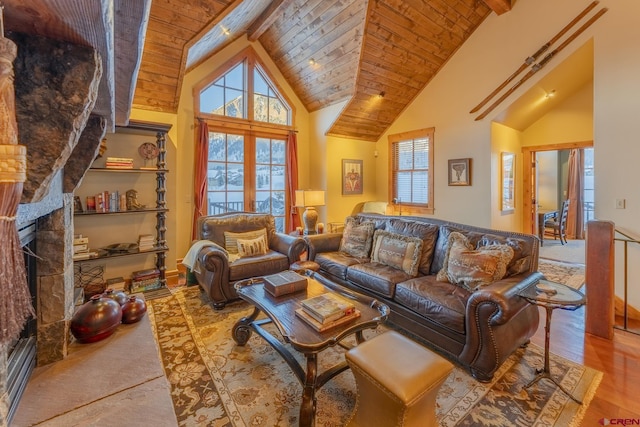 living room featuring a fireplace, high vaulted ceiling, light wood-type flooring, and a healthy amount of sunlight