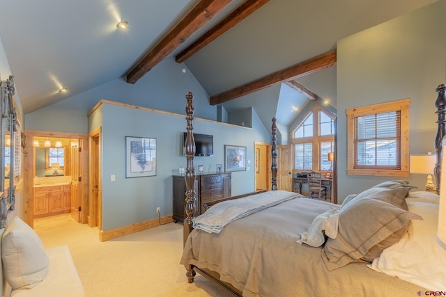 bedroom with ensuite bathroom, light carpet, and vaulted ceiling with beams