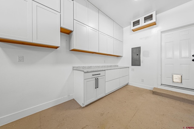 kitchen with white cabinetry and electric panel