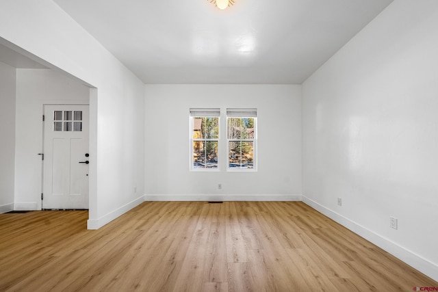 spare room featuring light hardwood / wood-style floors