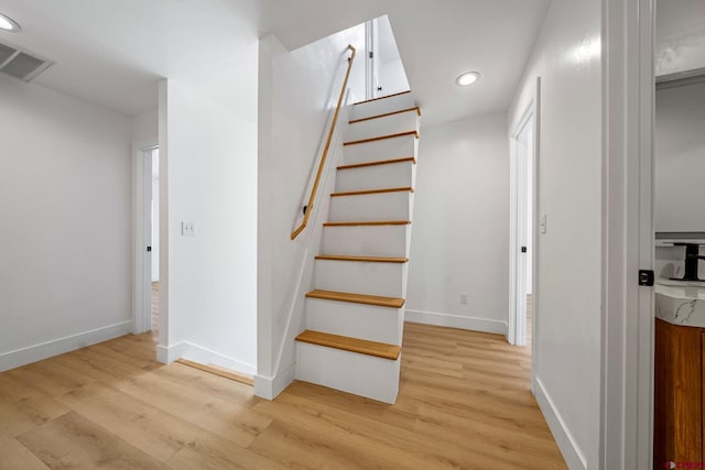 stairs featuring hardwood / wood-style floors