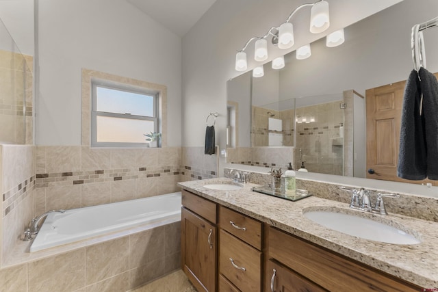 bathroom with vanity and independent shower and bath