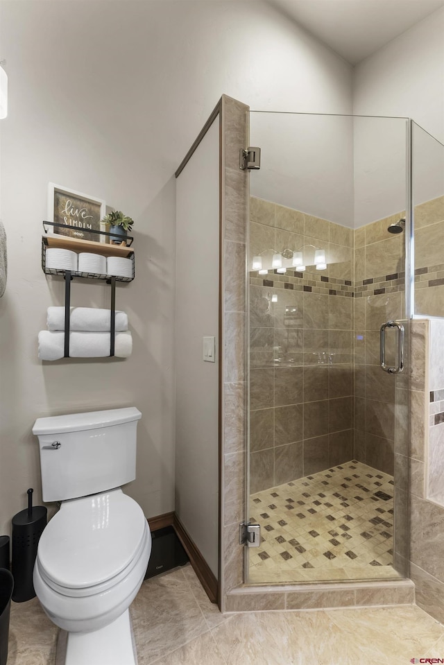 bathroom featuring a shower with shower door, toilet, and tile patterned flooring