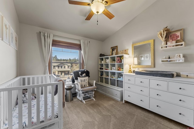 bedroom featuring ceiling fan, a nursery area, vaulted ceiling, and light carpet