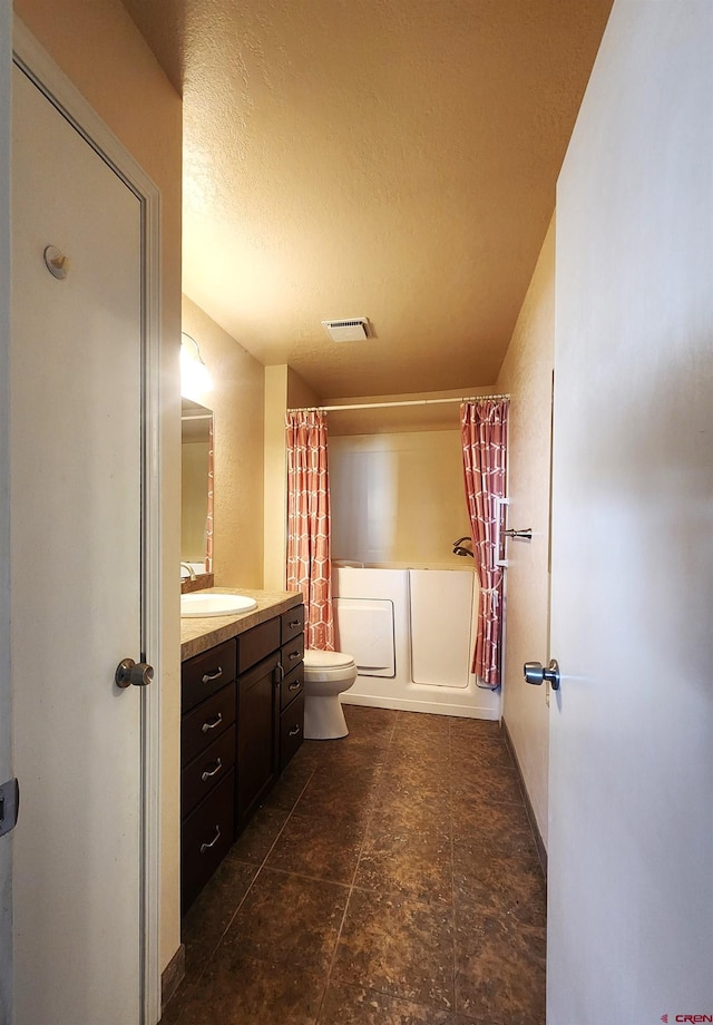 full bathroom featuring toilet, a textured ceiling, vanity, and shower / tub combo with curtain