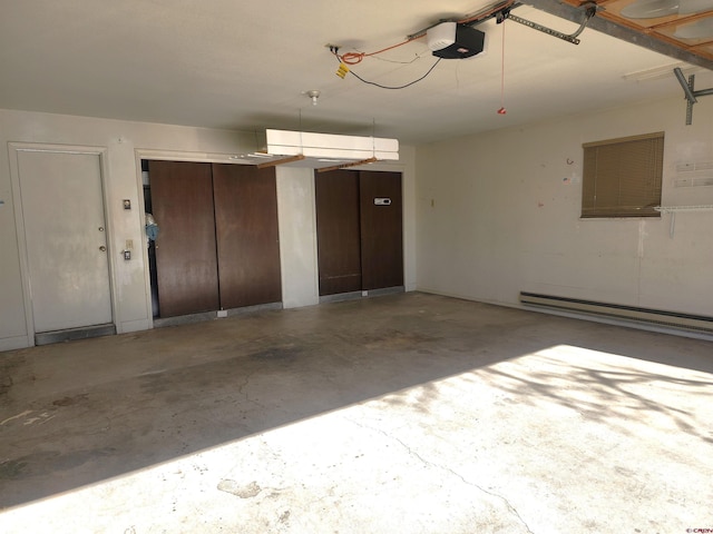 garage with a garage door opener and a baseboard radiator