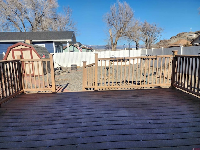 wooden deck featuring a storage unit