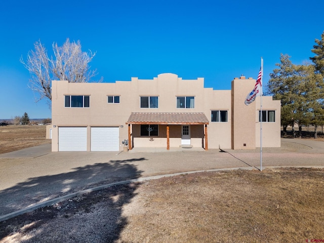 southwest-style home featuring a garage