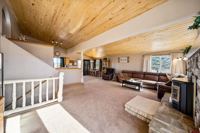 living room featuring wooden ceiling, lofted ceiling, and a wood stove