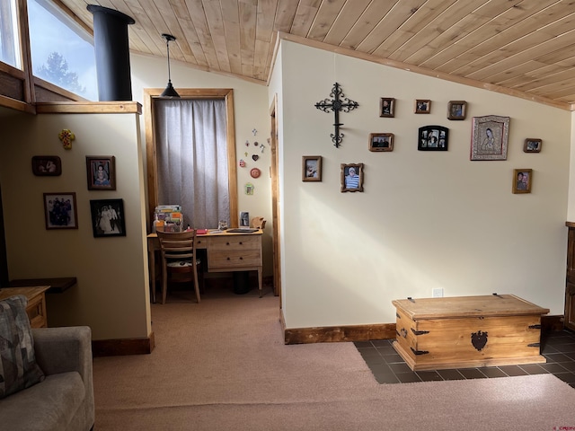 interior space featuring lofted ceiling, wood ceiling, and dark colored carpet