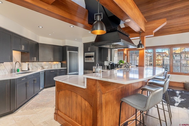 kitchen featuring tasteful backsplash, sink, pendant lighting, stainless steel dishwasher, and a center island