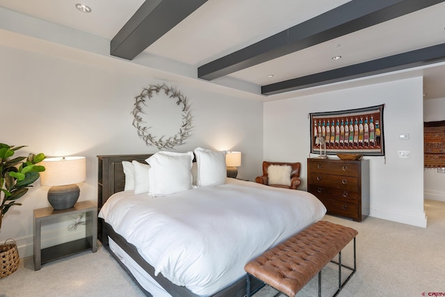 carpeted bedroom with beamed ceiling