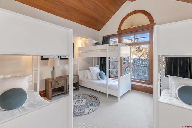 bedroom featuring light carpet, vaulted ceiling, wood ceiling, and multiple windows