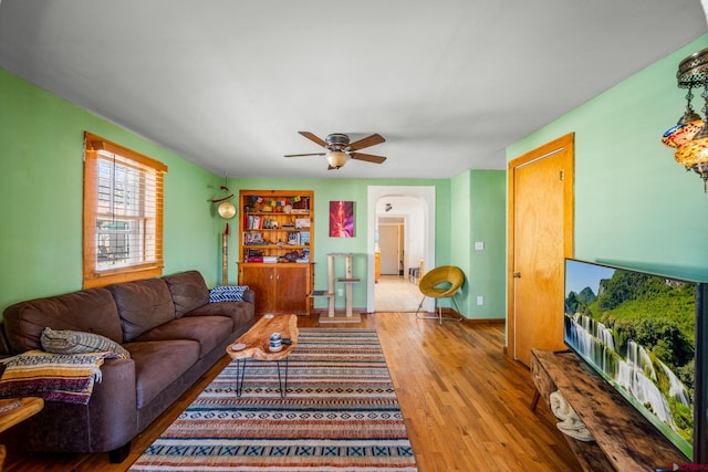 living room featuring ceiling fan and wood-type flooring