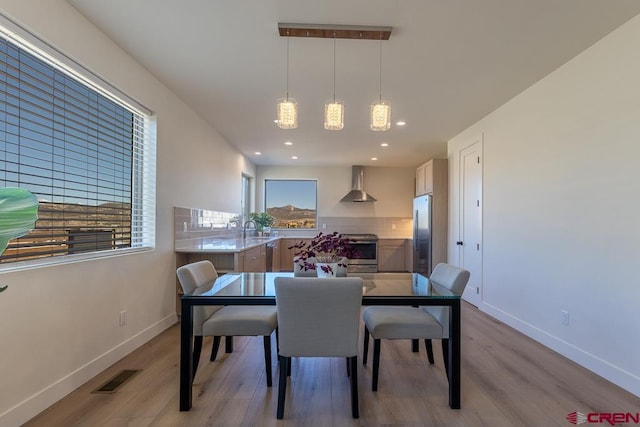 dining space featuring light hardwood / wood-style flooring and sink