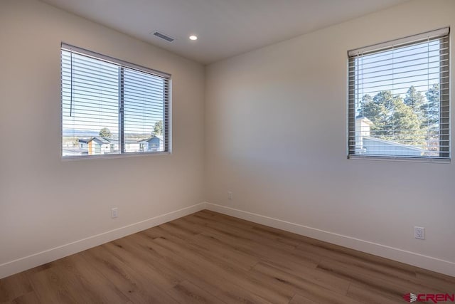 unfurnished room featuring hardwood / wood-style floors