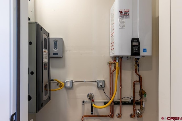 utility room with water heater and tankless water heater