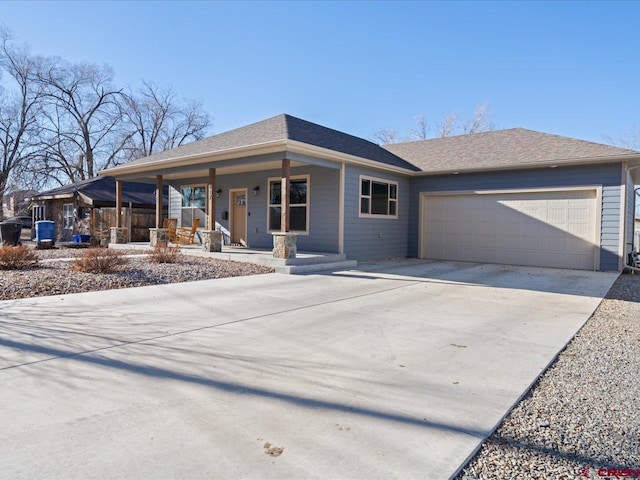 view of front of property with covered porch and a garage