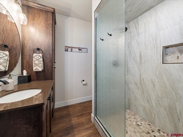 bathroom with vanity, wood-type flooring, and a shower