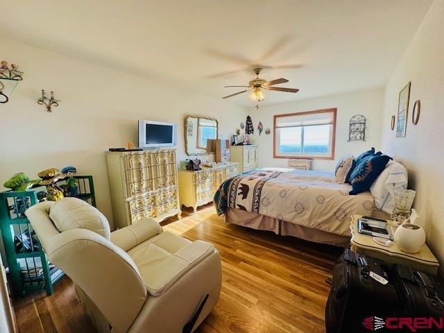 bedroom featuring ceiling fan and wood-type flooring