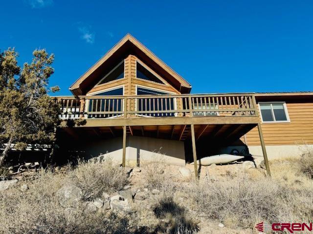 rear view of property with a wooden deck