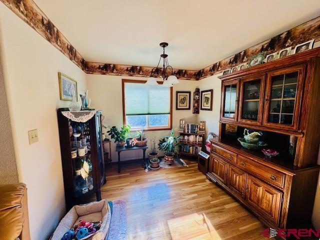 dining room featuring light hardwood / wood-style flooring and a chandelier