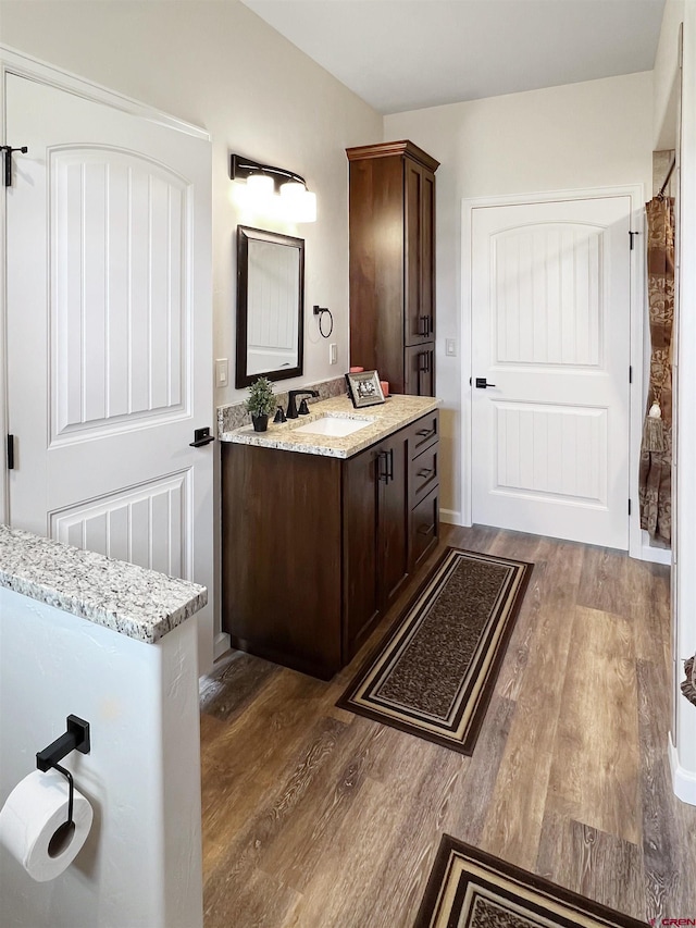 bathroom with vanity and hardwood / wood-style floors