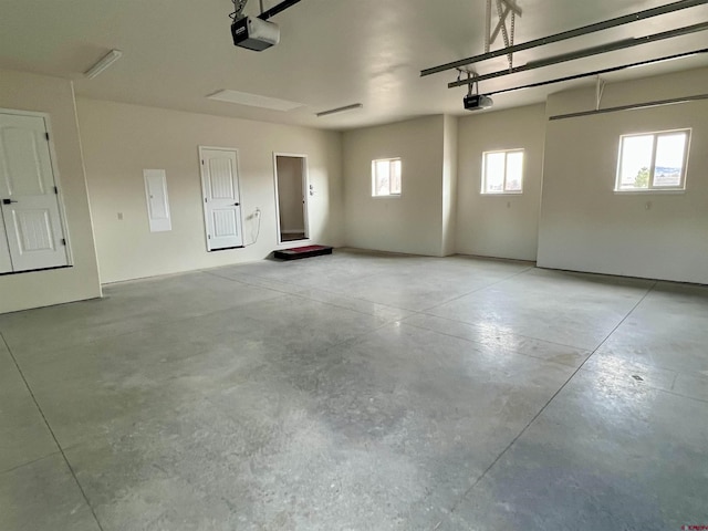 garage with electric panel and a garage door opener