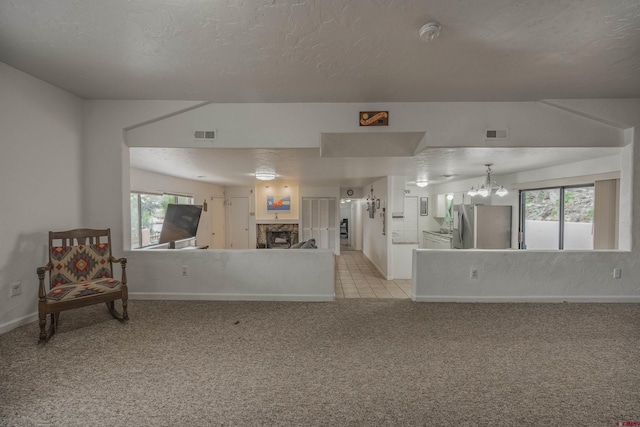 interior space with light carpet and a notable chandelier