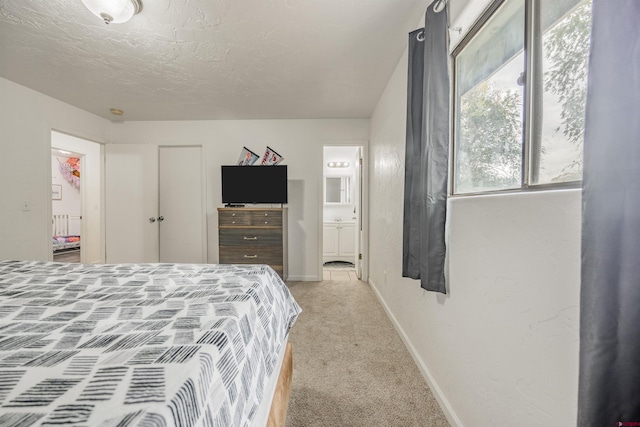 bedroom featuring ensuite bath and carpet floors