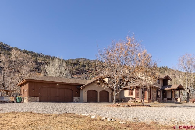 view of front of house with a garage and a mountain view