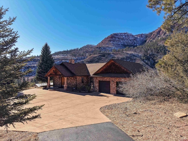 view of front of house featuring a garage and a mountain view