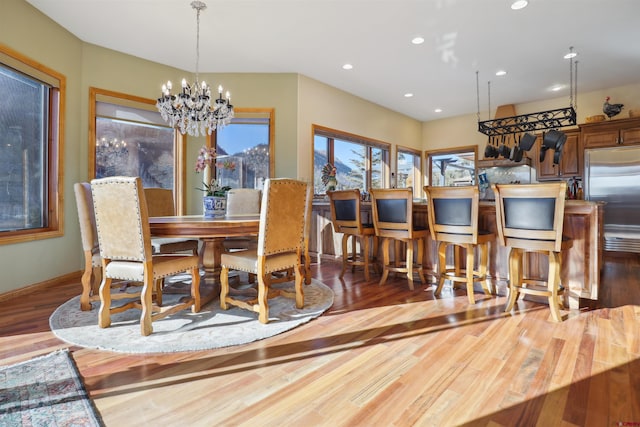 dining room featuring wood-type flooring and a notable chandelier