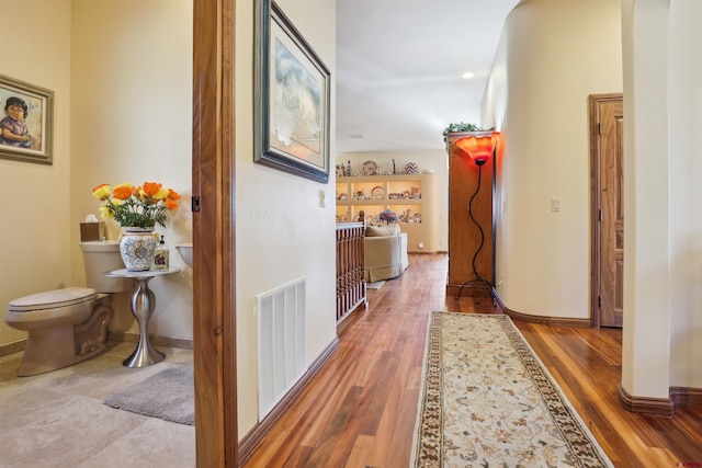 corridor with wood-type flooring