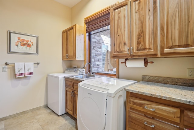 laundry area featuring cabinets, separate washer and dryer, sink, and light tile patterned flooring