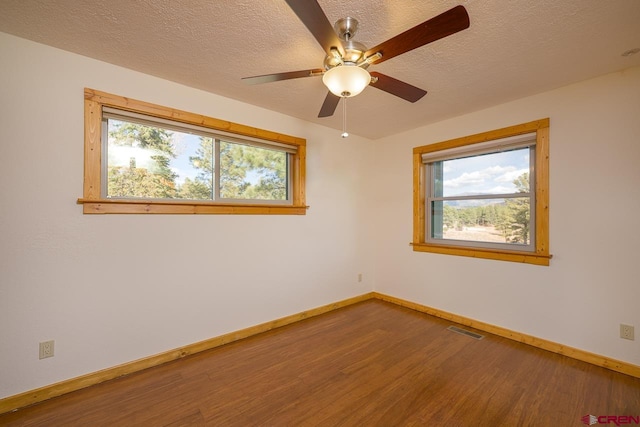 unfurnished room featuring a textured ceiling, ceiling fan, and wood-type flooring