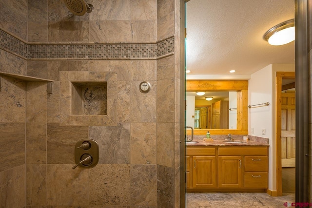 bathroom with vanity and a tile shower