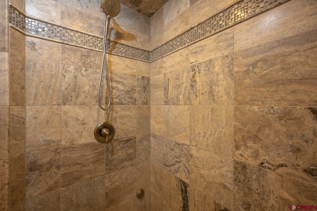 interior details with a tile shower