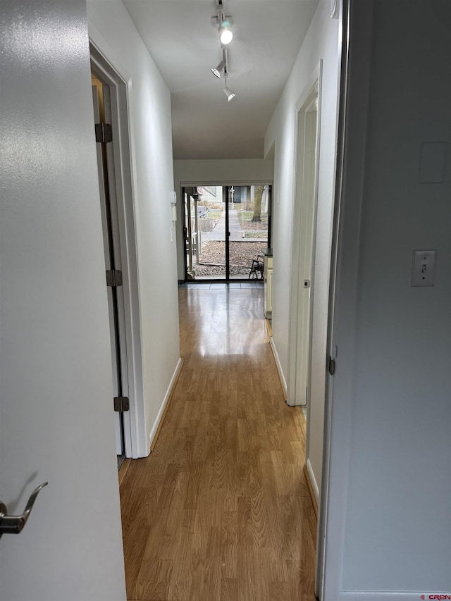 hall with light hardwood / wood-style flooring