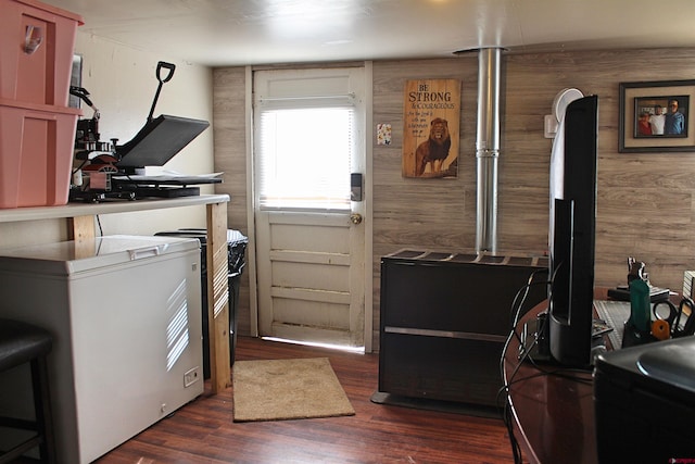 clothes washing area with dark hardwood / wood-style flooring and wood walls