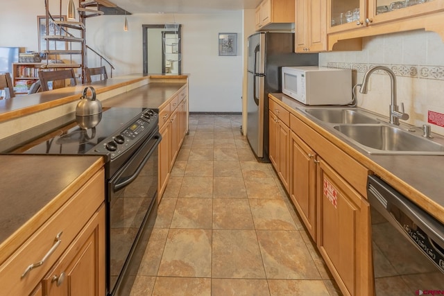 kitchen featuring black appliances, light tile patterned floors, decorative backsplash, and sink