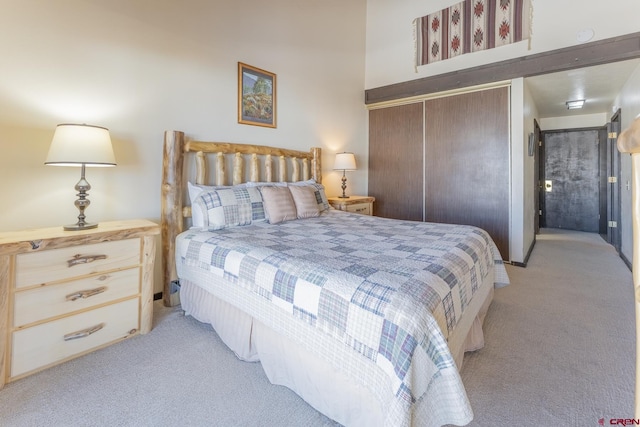 bedroom with light carpet and a closet