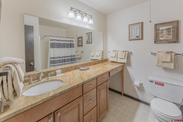 bathroom featuring toilet, vanity, and curtained shower